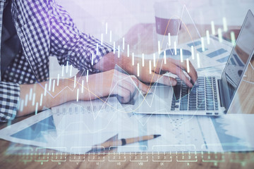 Multi exposure of stock market chart with man working on computer on background. Concept of financial analysis.