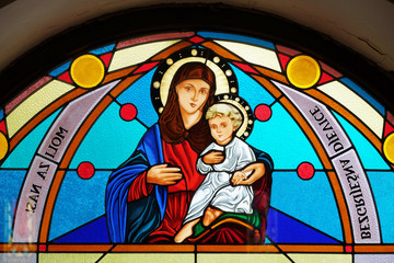 Virgin Mary with baby Jesus, stained glass window in the Shrine of the Our Lady Queen of Peace in Hrasno, Bosnia and Herzegovina
