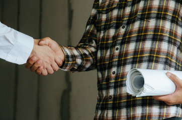 construction worker team contractor shaking hands with engineer after finishing up business meeting to start up project contract in construction site building, teamwork, partnership, industry concept