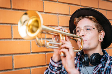 Side view of an caucasian man playing trumpet