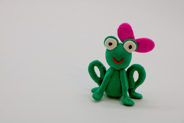 toy plasticine frog on a white background