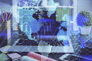Financial chart drawing and table with computer on background. Multi exposure. Concept of international markets.