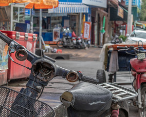 rusty old moped with broken headlight