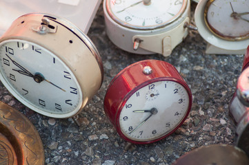 Closeup of vintage clocks at the flea market in the street