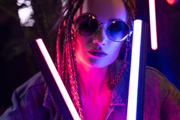 Close up portrait of a beautiful girl with an cornrows, wearing a denim jacket and sunglasses,...