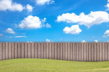 Empty wooden garden fence at backyard and blue sky background at a summer day