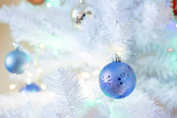 Blue ball hanging on silver christmas tree, good as background.