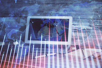 Financial graph colorful drawing and table with computer on background. Double exposure. Concept of international markets.