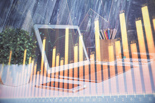Financial graph colorful drawing and table with computer on background. Double exposure. Concept of international markets.