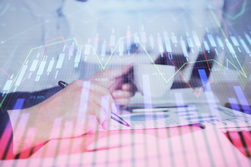 Double exposure hands with stock market chart.