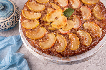 French sweet pie tart tatin apple cake upside down  over on gray concrete background. Top view