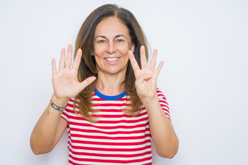 Middle age senior woman standing over white isolated background showing and pointing up with fingers number nine while smiling confident and happy.