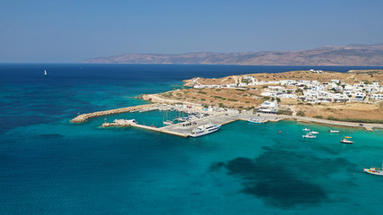 Fototapeta premium Aerial drone photo of famous sandy turquoise beach of Ammos and main port of Koufonisi island, Small Cyclades, Greece
