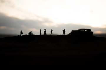 Fototapeta premium War concept. Creative composition. Silhouette of German general at the desert. Army commanders watching to the battle.