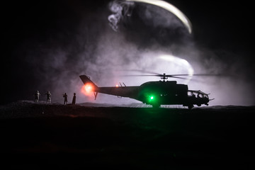 Silhouette of military helicopter ready to fly from conflict zone. Decorated night footage with...