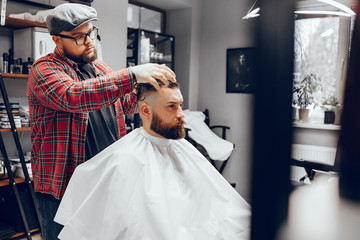 Man with a beard. Hairdresser with a client. Man in a red shirt