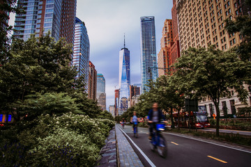 Hudson River Greenway and cyclists with One WTC view in New York City