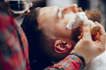 Man with a beard. Hairdresser with a client.