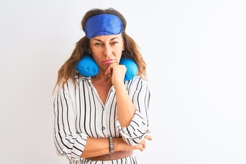 Middle age tourist woman wearing neckpillow and sleep mask over isolated white background thinking looking tired and bored with depression problems with crossed arms.