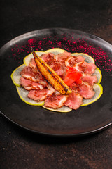 carpaccio meat duck and pear (savory snack, gourmet cuisine) menu concept. food background. copy space. Top view