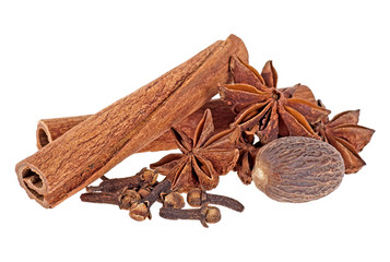 Aromatic spices isolated on a white background - cinnamon sticks, star anise, nutmeg and clove.