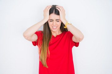 Young beautiful woman wearing casual red t-shirt over white isolated background suffering from headache desperate and stressed because pain and migraine. Hands on head.