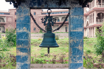 Bells in a Chinese temple, against the backdrop of buildings.