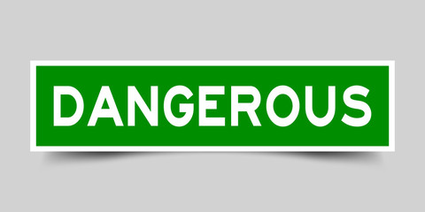 Label sticker in green color square shape as word dangerous on white background