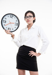 Smiling asian business woman in eyeglasses holding clock and looking at the camera over white background with clipping path.