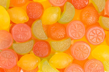 background of gummy candy of lemon, lime, orange and grapefruit