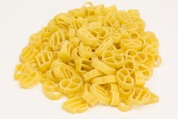 heap of raw pasta noodles in the shape of pretzels and beer mugs