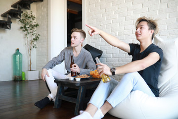 Football fans watch the match and drink beer