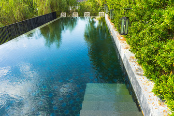 Naklejka premium Swimming pool with green trees at home