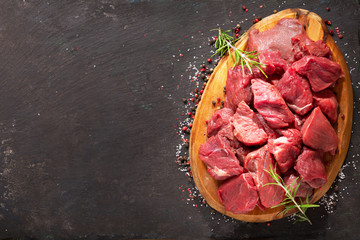 fresh chopped meat with rosemary on wooden board