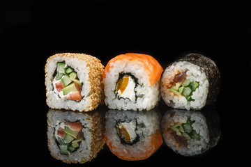 Set of sushi and maki rolls on the glass table