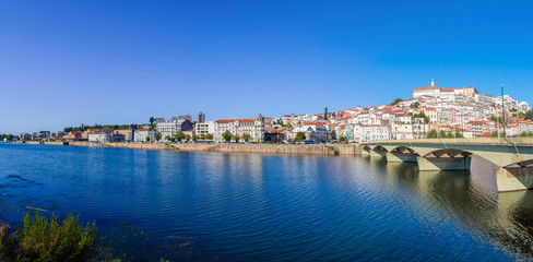 Fototapeta na wymiar Santa Clara Bridge with the old town on the hill in the background. Coimbra, Portugal