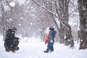 Kids walk in the park first snow