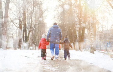 Fototapeta na wymiar Children play outside in the winter. Snow games on street.