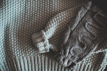 Knitted clothes folded closeup. Winter season concept.