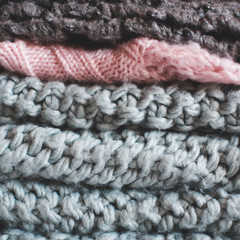 Stack of knitted clothing closeup. Winter season.