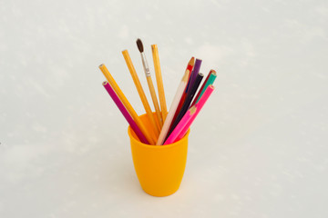 yellow glass pencil case with pencil and pen