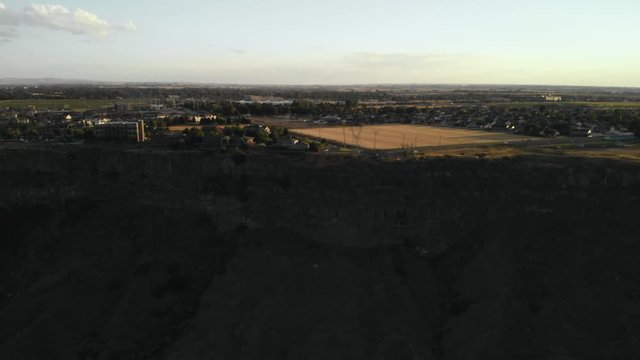 Aerial footage flying towards a crop field in the middle of an built up urban area near Twin Falls, Idaho, USA