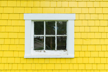 Old Window with Yellow Siding