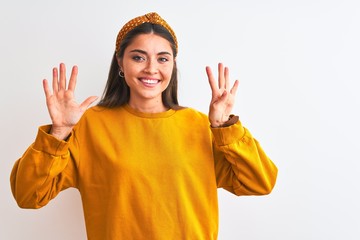 Young beautiful woman wearing yellow sweater and diadem over isolated white background showing and...