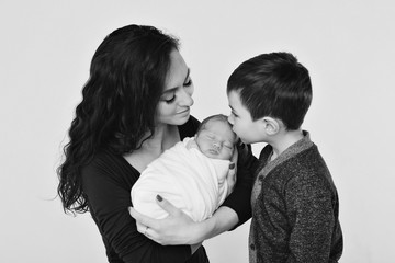 family photo on a white background: woman and boy spend time with children. hug the baby. the concept of childhood, fatherhood, motherhood, IVF