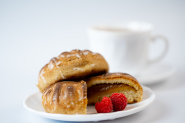 Gingerbread cookies with raspberries and tea on a white background