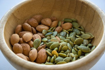 Mix with almonds, and pumpkin seeds in a wooden bowl