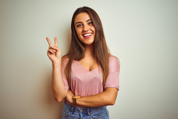Young beautiful woman wearing casual t-shirt standing over isolated white background smiling with...