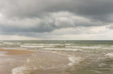 Fototapeta na wymiar rough sea under dark clouds, Baltic, Poland,
