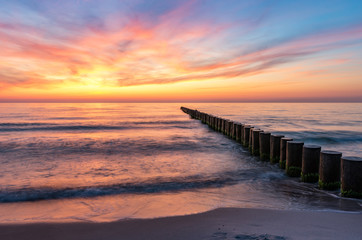 Fototapeta na wymiar Baltic sea seascape at sunset, Poland, wooden breakwater and waves